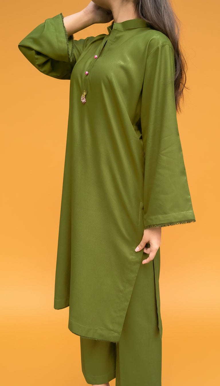 Green traditional outfit on a person against an orange background